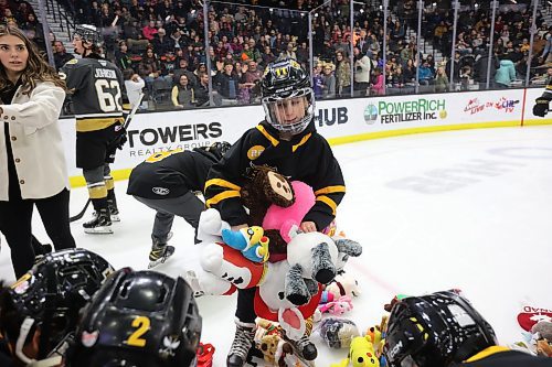 07122024
Volunteers and Brandon Wheat Kings players clean up hundreds of stuffed animals after the Teddy Bear Toss goal  during the first period of WHL action against the Prince Albert Raiders at Westoba Place on Saturday evening. The stuffed animals and other items are collected for Brandon-Westman Christmas Cheer. 
(Tim Smith/The Brandon Sun)