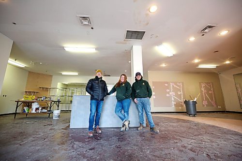 John Howard Society executive director Ross Robinson, left, poses with Elizabeth Morrow, the retail lead for Brandon's Food Rescue Grocery Store, and logistics support Donovan Kimball in the store's future home in the Town Centre Mall on Thursday afternoon. Renovations to the new space, which is more than double the current space of the Food Rescue's Rosser Avenue location, are moving forward in anticipation of an April 3 opening. (Matt Goerzen/The Brandon Sun)