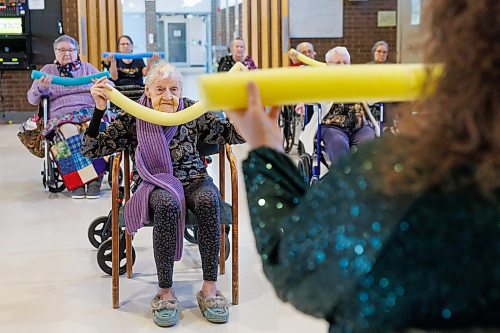 MIKE DEAL / FREE PRESS
Ellen wearing a long purple scarf uses her yellow noodle while participating in &#x201c;noodle hockey&#x201d; a popular recreation activity at Fred Douglas Lodge (1275 Burrows Ave). 

Reporter: Maggie Macintosh
241219 - Thursday, December 19, 2024.