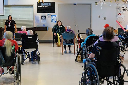 MIKE DEAL / FREE PRESS
Activity worker, Jenna Corby (sitting facing camera), leads residents participating in &#x201c;noodle hockey&#x201d; a popular recreation activity at Fred Douglas Lodge (1275 Burrows Ave). 

Reporter: Maggie Macintosh
241219 - Thursday, December 19, 2024.