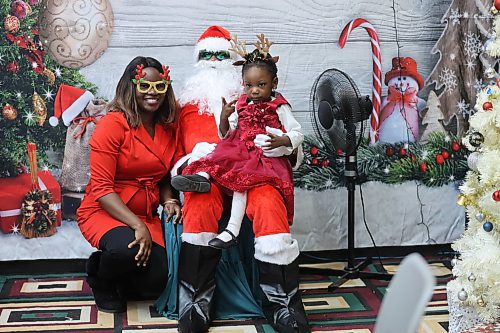 Left: Christianah Ayanniyi, Santa Claus (Middle) and Thelma Ayanniyi during the 2024 Christmas celebration organized by The Redeemed Christian Church of God Restoration Parish for children. Photos: Abiola Odutola/The Brandon Sun 