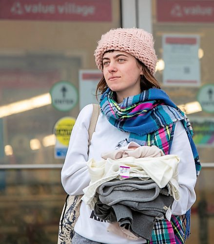 BROOK JONES/FREE PRESS
Opal Wolfe carries clothing items she purchased while shopping at Value Village on Ellice Avenue on Boxing Day in Winnipeg, Man., Thursday, Dec. 26, 2024. The donation centre no longer provides changing rooms for its customers to try on clothing.