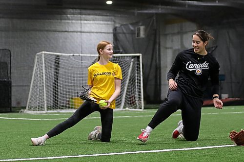 Danika Nell, right, instructs a young lefty pitcher during the last session of the day. (Thomas Friesen/The Brandon Sun)