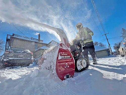 Jocelyn Funk, a.k.a. "The Snow Lady," uses a gas-powered hand-held snowblower to clean the back lane of a house at the corner of 12th Street and Lorne Avenue on Monday morning. The Brandon resident, who says she "loves to blow snow," was out yesterday morning volunteering her time in clearing sidewalks and driveways in the downtown area. (Matt Goerzen/The Brandon Sun)