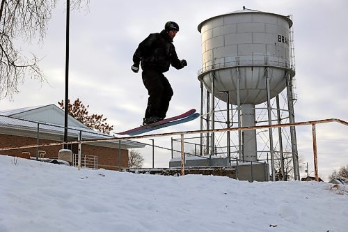 Alex Hall, a gold-medal Olympic skier, twists before landing back in a grind on a handrail in Rideau Park. (Connor McDowell/The Brandon Sun)