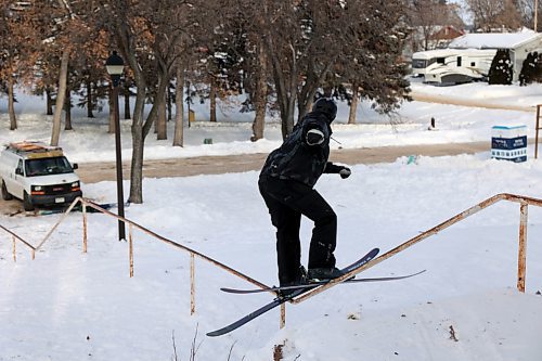 Alex Hall, a professional skier, grinds a handrail leading down a flight of stairs in Rideau Park. (Connor McDowell/The Brandon Sun)