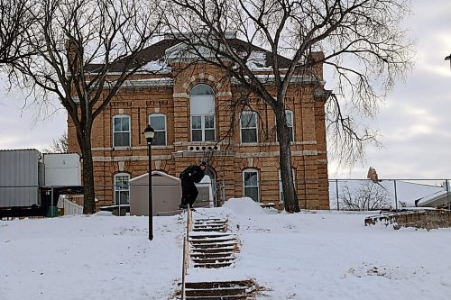 Alex Hall, a professional skier, grinds a handrail leading down a flight of stairs in Rideau Park. (Connor McDowell/Brandon Sun)