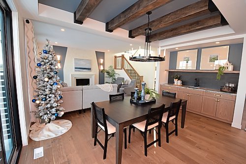 Todd Lewys / Free Press
Defined above by a gorgeous beamed tray ceiling and bordered on either side by a wet bar and sliding patio door, the dining area is a dazzling yet practical space.