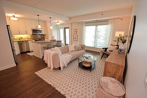 Todd Lewys / Free Press
The bright, well-positioned living room transitions smoothly into the beautifully finished island kitchen, which is next to a patio door leading out to a large, covered balcony that offers downtown and river views.
