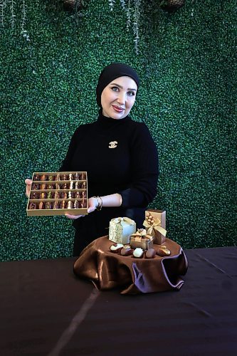 RUTH BONNEVILLE / FREE PRESS 
The Syrian-born founder of Tamara Dates, Noura Hamwi, shows off a box of her chocolate-covered dates filled with nuts.