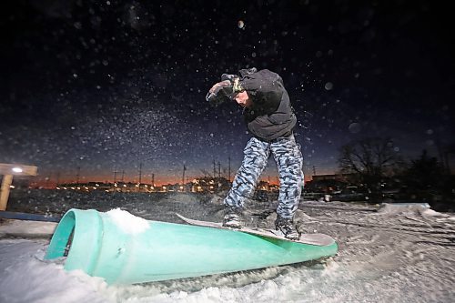 15012025
Chris Campbell snowboards in a backyard park he built with friends at his home along 17th Avenue East in Brandon on a mild Wednesday evening. Campbell built the majority of the park before the snow fell and he and his friends have been riding since the first snowfall. 
(Tim Smith/The Brandon Sun)