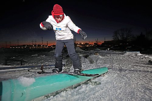 15012025
Alex Misanchuk frontside boardslides a rail in a backyard park at Chris Campbell&#x2019;s home along 17th Avenue East in Brandon on a mild Wednesday evening. Campbell and friends built the majority of the park before the snow fell and he and his friends have been riding since the first snowfall. 
(Tim Smith/The Brandon Sun)