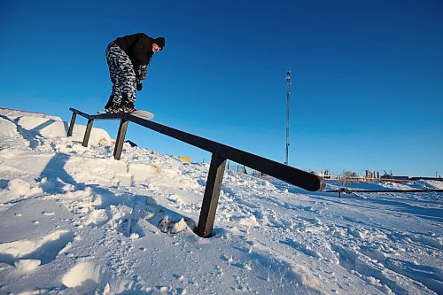 15012025
Chris Campbell grinds a rail while snowboarding in a backyard park he built with friends at his home along 17th Avenue East in Brandon on a sunny and warm Wednesday afternoon. Campbell built the majority of the park before the snow fell and he and his friends have been riding since the first snowfall. 
(Tim Smith/The Brandon Sun)