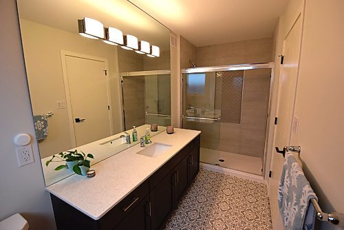 Todd Lewys / Free Press
The luxurious ensuite offers a tiled walk-in shower, cool mosaic-tile floor and maple vanity with quartz countertop.