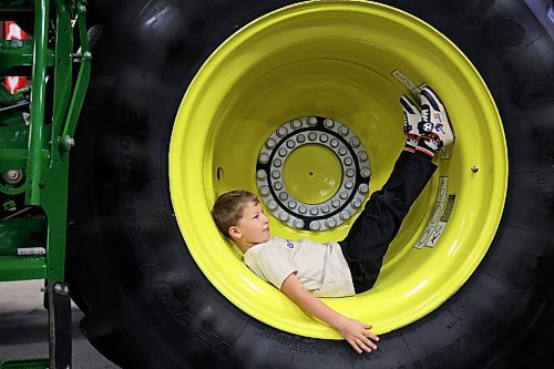 23012025
Atlas Friesen, six, of Altona, rests in the wheel well of a John Deere combine during the final day of Manitoba Ag Days at the Keystone Centre on Thursday.
 (Tim Smith/The Brandon Sun)