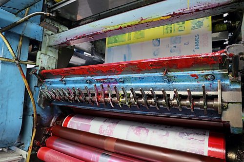Magenta, yellow, black and cyan ink are applied to newspaper at different stages of its print. A press unit is covered in ink as staff at the Killarney Guide run a paper through the press. (Connor McDowell/Brandon Sun)