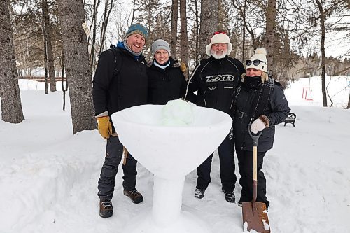 Left: Bruce Jasperson, Liz Wilson, Brett Griffiths, and Jodie Ponton pose for picture behind a Martini cup with olives they carved with snow at the Friends Learning Centre Riding Mountain national Park Saturday afternoon. (Abiola Odutola/The Brandon Sun)