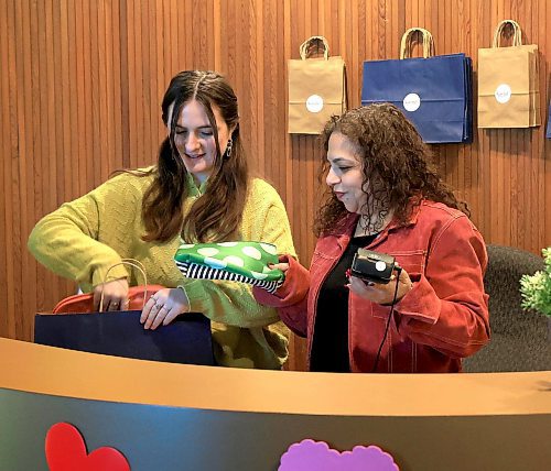 RUTH BONNEVILLE / FREE PRESS
VOLUNTEERS
Photo of Aviva Tabac (pink jacket) community engagement manager at Kavod, a new thrift store on Notre Dame with her sales personal, Noa Kaufman, at the till packaging up items for customer Wednesday.
Story: Aviva Tabac (she/her), community engagement manager at Kavod, a new thrift store on Notre Dame.
This is for my Feb. 10 volunteers column.
See story by Aaron
Feb 5th, 2025