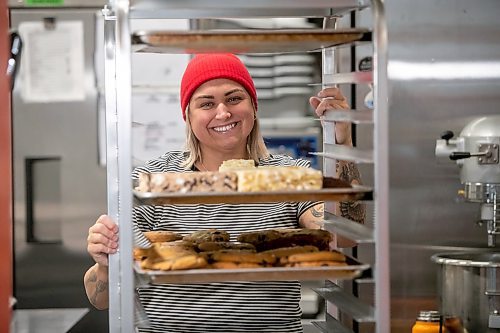 BROOK JONES/FREE PRESS
Black Market Provisions at 550 Osborne St. in Winnipeg, Man., source goods locally and within Canada as a way of encourging customers to shop local. Black Market Provisions co-owner Angela Farkas, 42, pushes a baking tray rack trolley with fresh baking as she is pictured Wednesday, Feb.. 5, 2025. Farkas baked dark chocolate sea salt cookies, Oreo rice crispie squares, ruffles squares and red velvet Oreo cookies, which are the feature of the month.