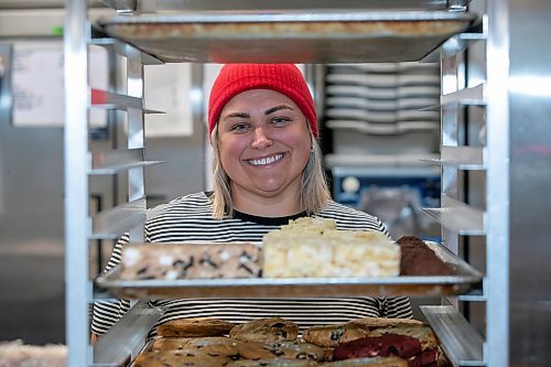 BROOK JONES/FREE PRESS
Black Market Provisions at 550 Osborne St. in Winnipeg, Man., source goods locally and within Canada as a way of encourging customers to shop local. Black Market Provisions co-owner Angela Farkas, 42, pushes a baking tray rack trolley with fresh baking as she is pictured Wednesday, Feb.. 5, 2025. Farkas baked dark chocolate sea salt cookies, Oreo rice crispie squares, ruffles squares and red velvet Oreo cookies, which are the feature of the month.