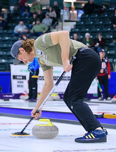 Eric Zamrykut of Team Jeff Stewart sweeps a stone. (Matt Packwood/The Brandon Sun)