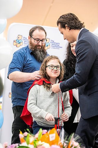 MIKAELA MACKENZIE / FREE PRESS
	

Nine-year-old Jack Johnson, Manitoba&#x573; newest Children&#x573; Hospital Foundation champion child, gets his cape put on by Children&#x573; Hospital manager of corporate and community partnerships Andrew Ferris at the St. Vital Walmart on Thursday, Feb. 6, 2025. Jack was born at 26 weeks, weighing barely two pounds, and had five brain surgeries before turning two. He will participate in various events for the foundation this year, raising money and awareness for kids who need care.

Standup.
Winnipeg Free Press 2025