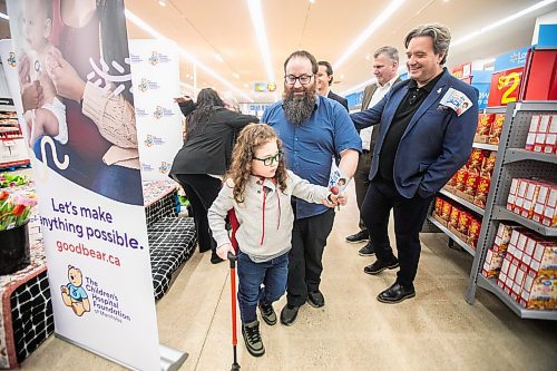 MIKAELA MACKENZIE / FREE PRESS
	

Nine-year-old Jack Johnson, Manitoba&#x573; newest Children&#x573; Hospital Foundation champion child, walks off the stage with his dad, Jason Johnson, as Children&#x573; Hospital president and CEO Stefano Grande (right) congratulates him after the announcement at the St. Vital Walmart on Thursday, Feb. 6, 2025. Jack was born at 26 weeks, weighing barely two pounds, and had five brain surgeries before turning two. He will participate in various events for the foundation this year, raising money and awareness for kids who need care.

Standup.
Winnipeg Free Press 2025