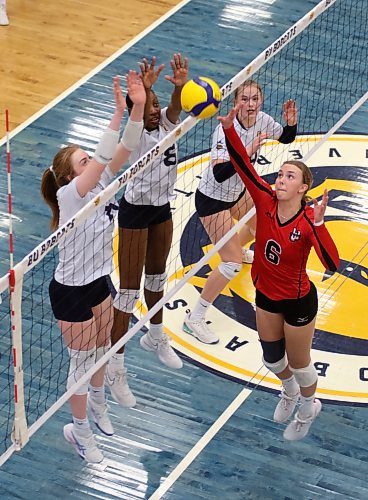 Winnipeg Wesmen setter Breanne Bazin (6) tips against Brandon's Carly Thomson, left, and Nerissa Dyer during their Canada West women's volleyball match at the Healthy Living Centre on Friday. (Thomas Friesen/The Brandon Sun)