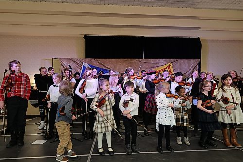 Suzuki Tour Group plays violins during their performance at the Scottish pavilion Saturday afternoon. (Abiola Odutola/The Brandon Sun)