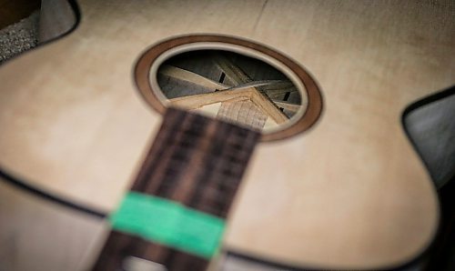 JOHN WOODS / FREE PRESS
One of Phil Campbell-Enns’ guitars is photographed in his basement workshop Tuesday, February 11, 2025. Campbell-Enns, a pastor at Home Street Mennonite Church, side hustle is building acoustic guitars in his basement workshop.

Reporter: dave