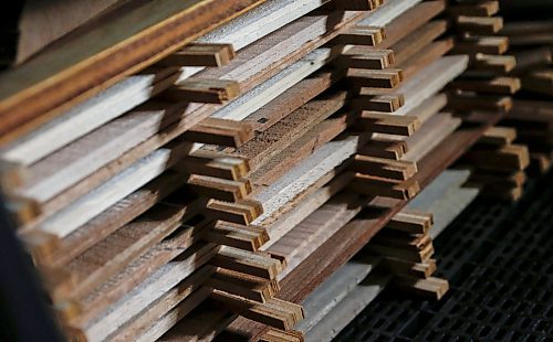 JOHN WOODS / FREE PRESS
Some fronts and backs of future Phil Campbell-Enns guitars sit on a shelf in his basement workshop Tuesday, February 11, 2025. Campbell-Enns, a pastor at Home Street Mennonite Church, side hustle is building acoustic guitars in his basement workshop.

Reporter: dave