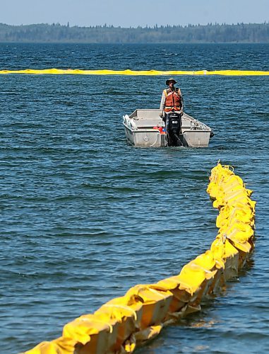 31072024
Workers with ASI Group work to move silt curtains into Clear Lake at the Clear Lake boat cove in Riding Mountain National Park on Wednesday. The silt curtains are being set up in Clear Lake from boat cove to the pier as part of extensive work by Parks Canada in the wake of limited zebra mussel activity being found in the lake. 
(Tim Smith/The Brandon Sun)