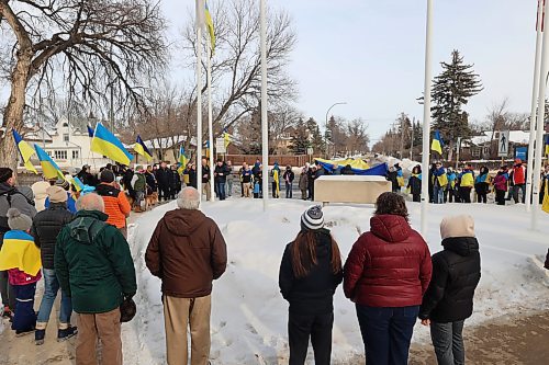 Ukrainians based in Brandon and residents gather for flag raising in front of Brandon University in solidarity with Ukraine reaching its three-years mark of war. (Abiola Odutola/The Brandon Sun)