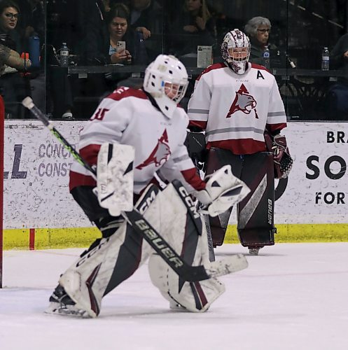 AC's Rachel Halldorson warms up under the watchful eye of Payton Murray. (Matt Packwood/The Brandon Sun) Feb. 22, 2025