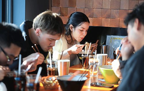 Ruth Bonneville / Free Press

BIZ - Kinton Ramen

Photo of customer. Renata Moura (centre) enjoying her bowl as she has  lunch with a group of colleagues Friday. 

Story: Kinton Ramen, a growing chain restaurant selling ramen dishes, is opening Friday. It&#x2019;s the brand&#x2019;s first location in Winnipeg

See story by Gabby  

February  21st, 2025