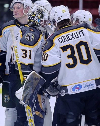 Mason Lobreau (31) and KC Couckuyt (30) bump helmets following a Neepawa Titans win. (Matt Packwood/The Brandon Sun)