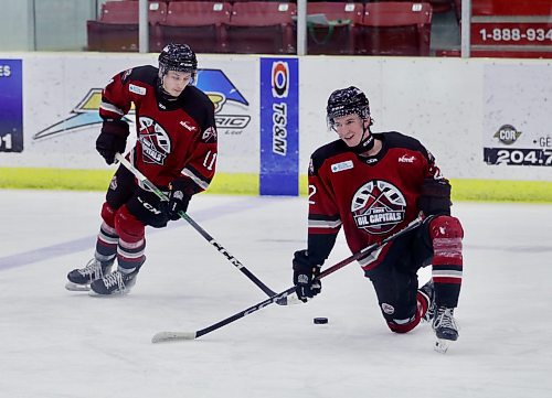 Luke Robson (11) uses Daniel Tokariwski (22) as a stick-handling obstacle during warm-ups . (Matt Packwood/The Brandon Sun) 