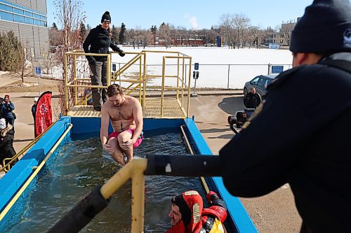 Brett Janz plunges in the water during the Polar Plunge Saturday afternoon. (Abiola Odutola/The Brandon Sun)