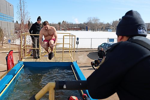 Brett Janz plunges in the water during the Polar Plunge Saturday afternoon. (Abiola Odutola/The Brandon Sun) 