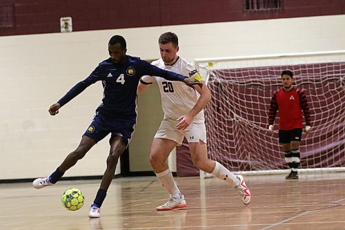 BU's Awall Osabutey dribbles while AC's Vadym Kochenko defends on Saturday. The Cougars put together a strong defensive performance to finish in third place in the regular season. (Thomas Friesen/The Brandon Sun)