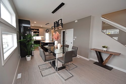 Todd Lewys / Free Press
A mod-style LED light fixture defines the spacious dining area, which is well situated next to a pair of oversized transom windows and a handy sideboard area.