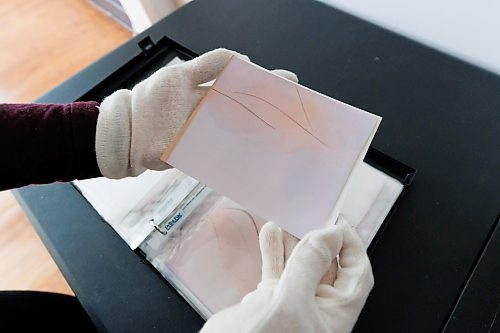 MIKE DEAL / FREE PRESS
Brenda Stuart is a photographer who specializes in solargraphy, a photographic method using a pinhole camera to capture the path of the sun. This is a form of pinhole photography using a long-exposure technique where the arc of the sun&#x2019;s trails are recorded onto photographic paper as the sun&#x2019;s position in the sky changes from solstice to solstice. Images can be made over a day, a week, a month, a year. Or even longer. A clear sunny day will record a strong bright arc across the photo paper. When the days are cloudy or partially cloudy the camera records dots and dashes.
Brenda keeps an archive of her photographic paper negatives in her studio. 
Reporter: AV Kitching
250225 - Tuesday, February 25, 2025.