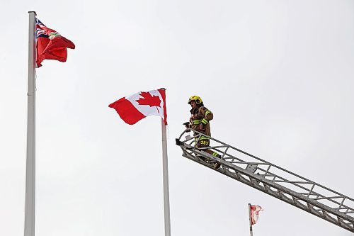 12032025
Devin Gellatly with Brandon Fire and Emergency Services replaces a Canadian flag atop The Dome Building in Brandon on Wednesday afternoon. BFES members took turns at the top of a ladder truck replacing multiple flags at The Dome Building. 
(Tim Smith/The Brandon Sun)default