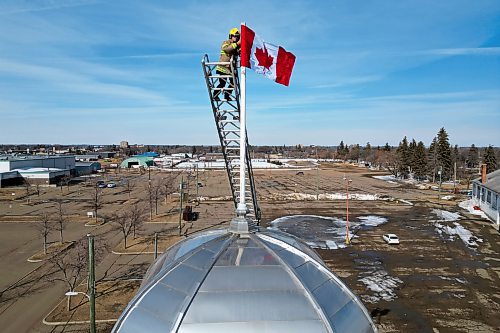 12032025
Corbin Mariash with Brandon Fire and Emergency Services replaces a Canadian flag atop one of the domes at The Dome Building in Brandon on Wednesday afternoon. BFES members took turns at the top of a ladder truck replacing multiple flags at The Dome Building.
(Tim Smith/The Brandon Sun)default