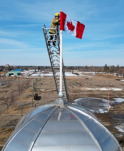 12032025
Corbin Mariash with Brandon Fire and Emergency Services replaces a Canadian flag atop one of the domes at The Dome Building in Brandon on Wednesday afternoon. BFES members took turns at the top of a ladder truck replacing multiple flags at The Dome Building.
(Tim Smith/The Brandon Sun)default