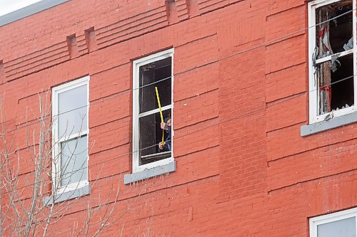 MIKE DEAL / FREE PRESS
A contractor measures one of the damaged window frames.
WFPS crews were still at the apartment building at 285 College Avenue where a fire was reported at 7:29 a.m. this morning. The city is reporting that there were no reported injuries and that the, “building sustained damage from smoke, fire, and water,” and that the cause of the fire is under investigation.
Reporter: Scott Billeck
250313 - Thursday, March 13, 2025.