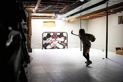 MIKAELA MACKENZIE / FREE PRESS
	

The boy who has been suspended from all hockey related activities in south Winnipeg by the South Winnipeg Hockey Association (due to his parents filing a defamation lawsuit against the association) shoots pucks in his basement training area on Friday, March 14, 2025. 

For Scott story.
Winnipeg Free Press 2025