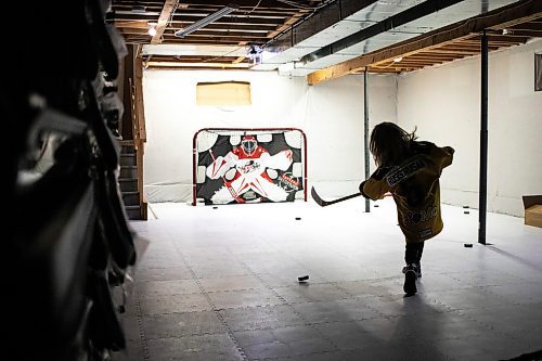 MIKAELA MACKENZIE / FREE PRESS
The boy who has been suspended from all hockey related activities in south Winnipeg by the South Winnipeg Hockey Association (due to his parents filing a defamation lawsuit against the association) shoots pucks in his basement training area on Friday, March 14, 2025.
For Scott story.
Winnipeg Free Press 2025
