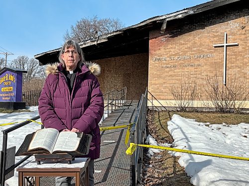 Pastor Trudy Thorarinson stands in front of Grace-St. John’s Anglican Lutheran Church in Carman after leading parishioners in a short time of ‘blessing and farewell’ to the building Sunday morning. The church was damaged in a fire Thursday. (Aaron Epp / Free Press)