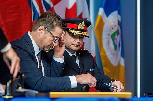 MIKE DEAL / FREE PRESS
Winnipeg Police Service Chief of Police Gene Bowers is sworn-in during a ceremony held at the Pinnacle Club, Princess Auto Stadium, Monday morning. 
Chief Bowers (right) signs documents with the Provincial Court Chief Judge Ryan Rolston (left) and Winnipeg Mayor Scott Gillingham (not pictured). 
250317 - Monday, March 17, 2025.